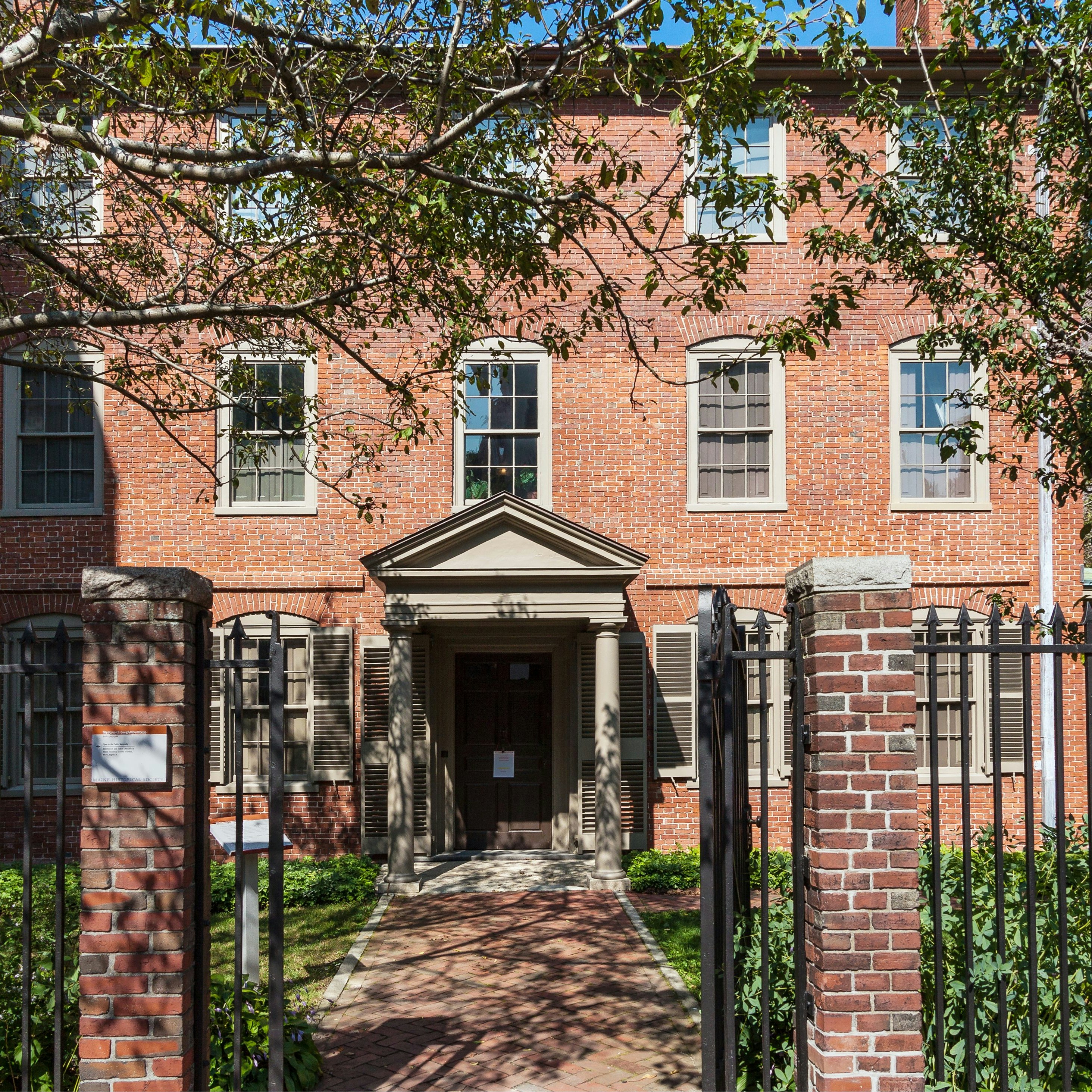 Portland, ME, USA - September 17, 2013: Wadsworth-Longfellow House, Portland, Maine, New England, USA. The Wadsworth-Longfellow House is Maine's first house museum. Henry Wadsworth Longfellow was a commanding figure in the cultural life of nineteenth-century America. Born in Portland, Maine, in 1807, he became a national literary figure by the 1850s, and a world- famous personality by the time of his death in 1882. Red brick colonial house, gates, green front yard with trees, bushes and grass and blue sky are in the image.
Longfellow House